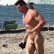 uncut nudist man running naked at the beach