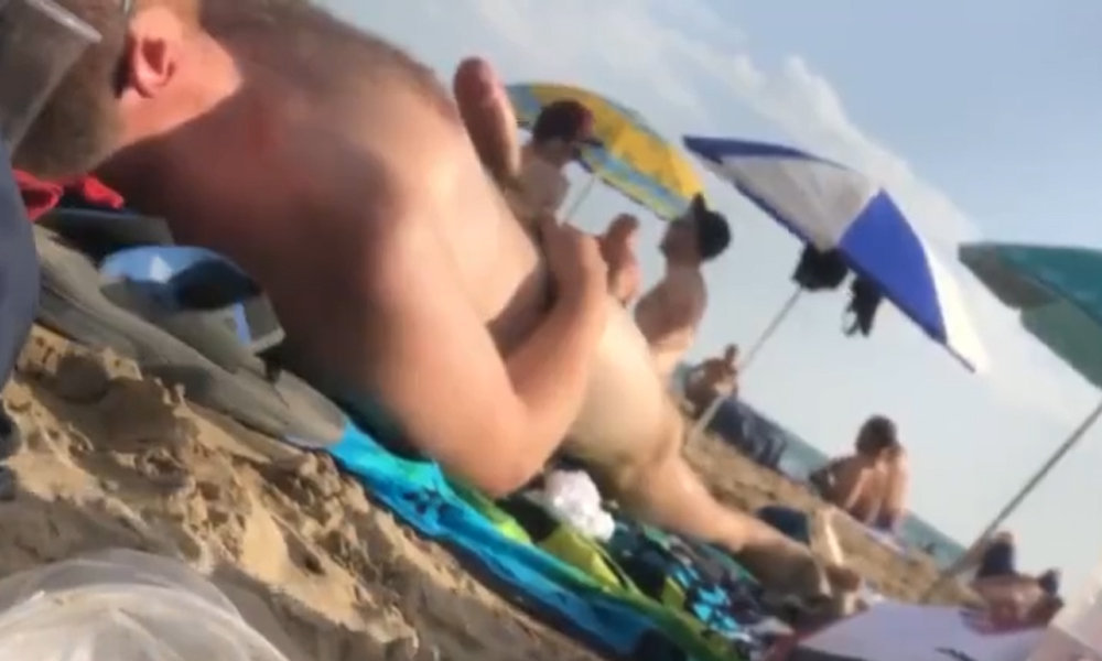 man getting a boner while sunbathing at nudist beach