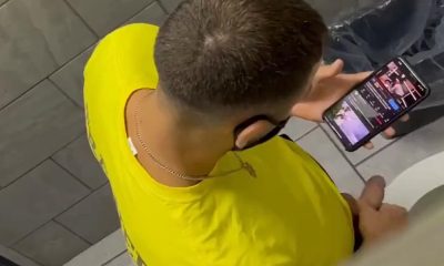 Jock peeing in a public toilet