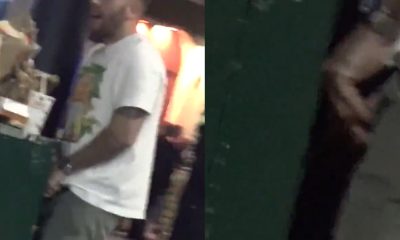 Guy caught peeing in a bin in the street