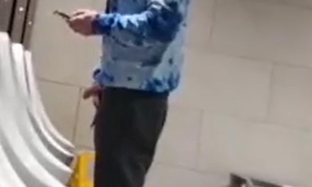 Hung lad caught taking a leak at urinals