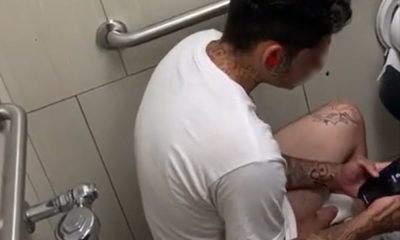 Tattooed guy caught masturbating in public toilet
