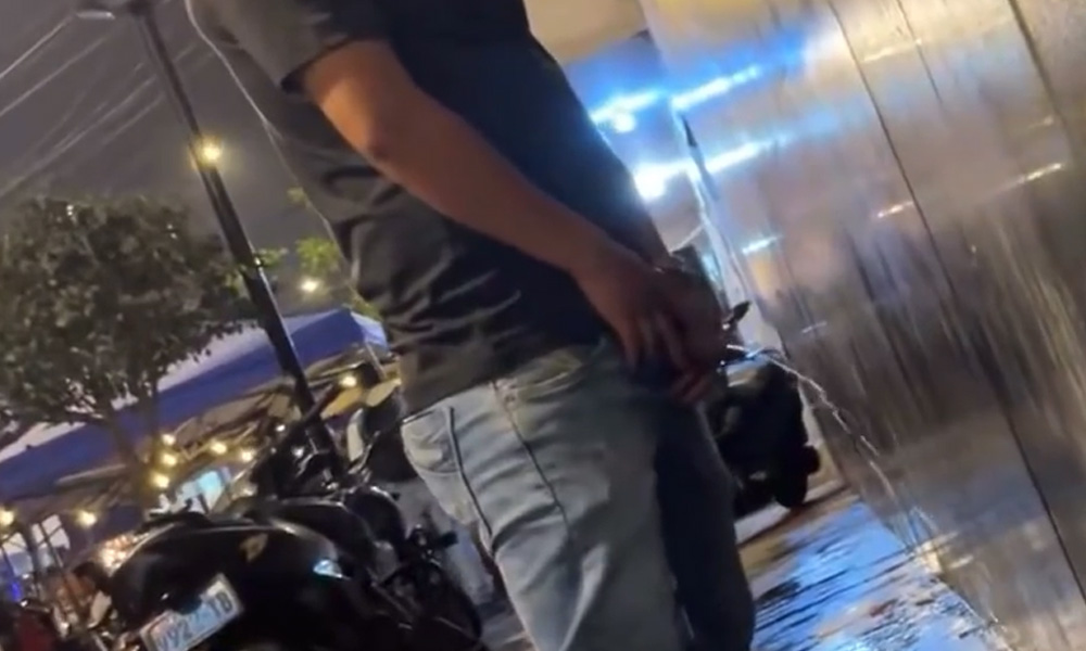 Handsome latin guy caught peeing in the street at night