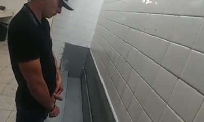 Latin guy with big dick pissing at urinals