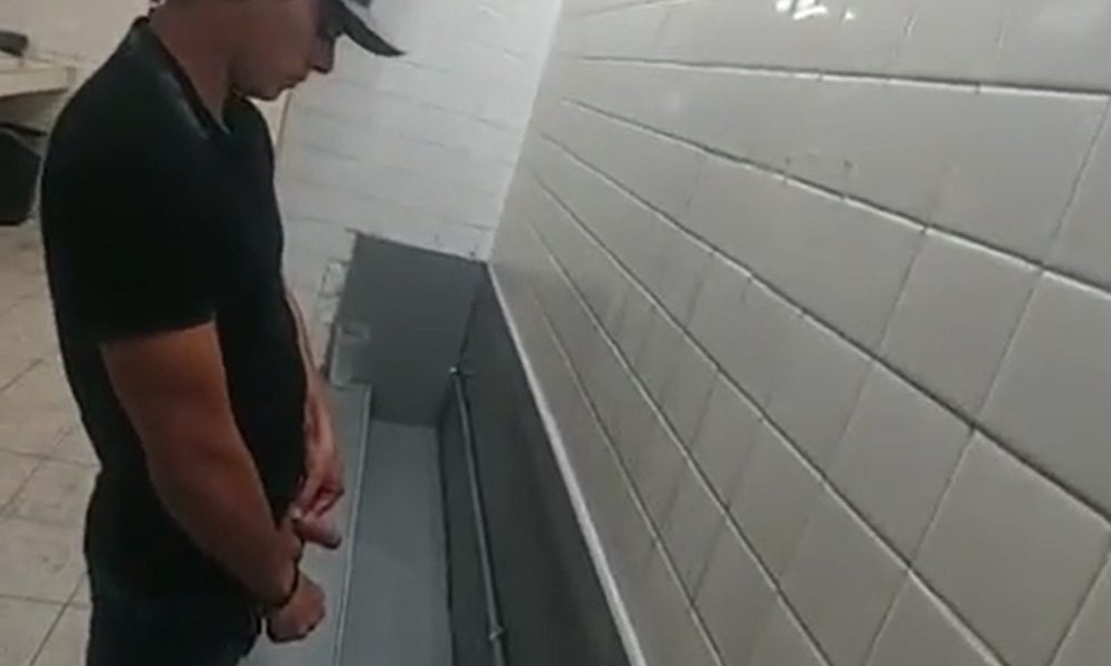 Latin guy with big dick pissing at urinals